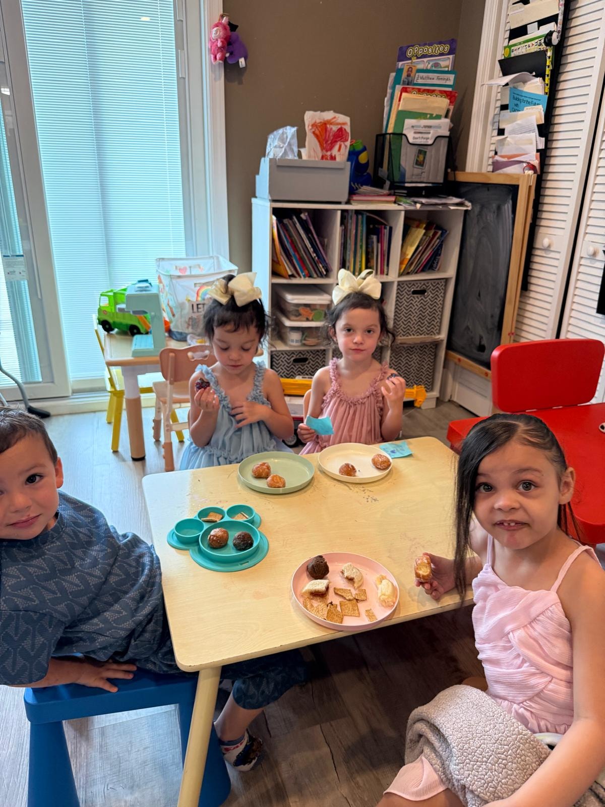 Children sitting together enjoying snack time at the table