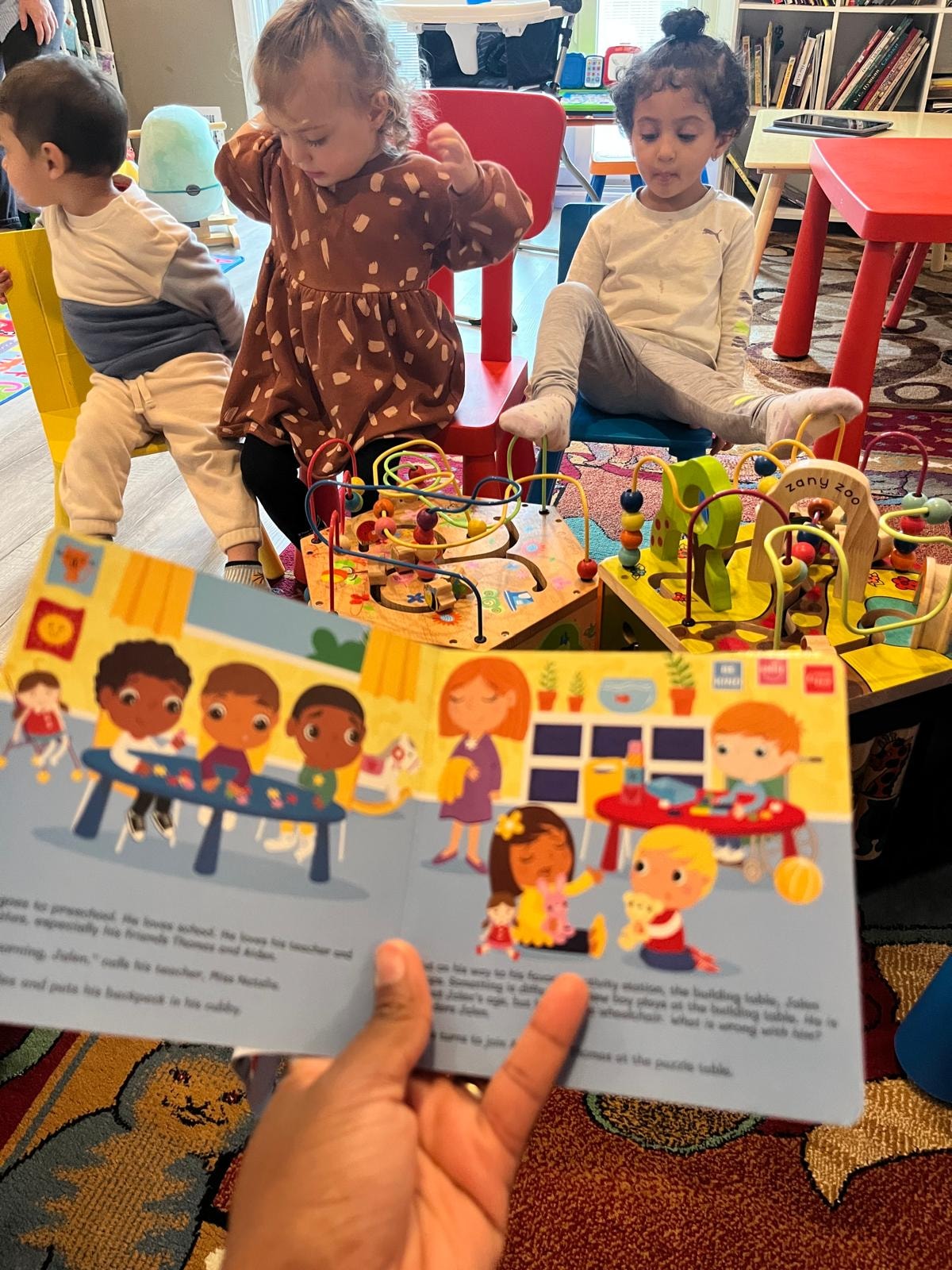 Teacher reading a story to a group of children at circle time
